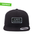 "Always Anxious" in white block text embroidered on black patch with white merrowed edge on a flat brim snap back. Art by Print Ritual.